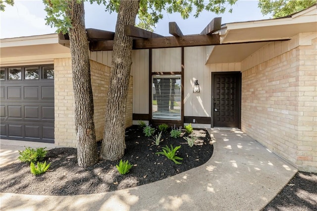 2008 Rayburn Ct, College Station, TX 77840 - view of exterior entry with brick siding and an attached garage