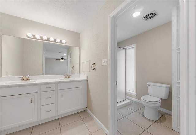 2008 Rayburn Ct, College Station, TX 77840 - full bath featuring tile patterned flooring, toilet, double vanity, baseboards, and ceiling fan