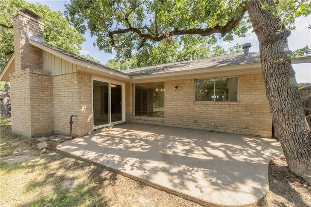 2008 Rayburn Ct, College Station, TX 77840 - rear view of property with brick siding, a chimney, a patio area, and roof with shingles