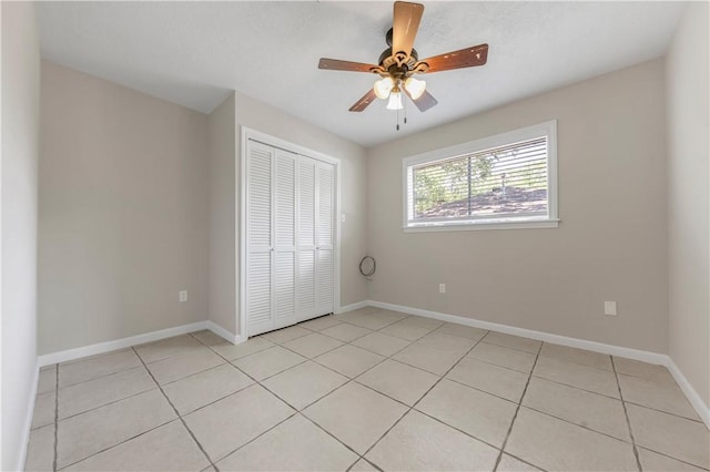 2008 Rayburn Ct, College Station, TX 77840 - unfurnished bedroom with a closet, light tile patterned flooring, baseboards, and a ceiling fan