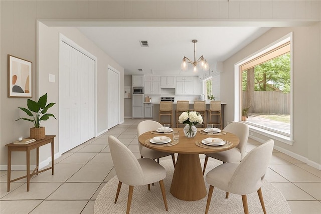 2008 Rayburn Ct, College Station, TX 77840 - dining space featuring light tile patterned flooring, a chandelier, and baseboards