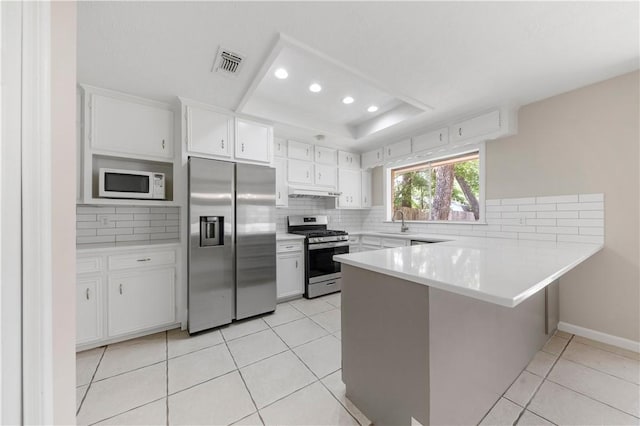 2008 Rayburn Ct, College Station, TX 77840 - kitchen with appliances with stainless steel finishes, a sink, a peninsula, decorative backsplash, and recessed lighting