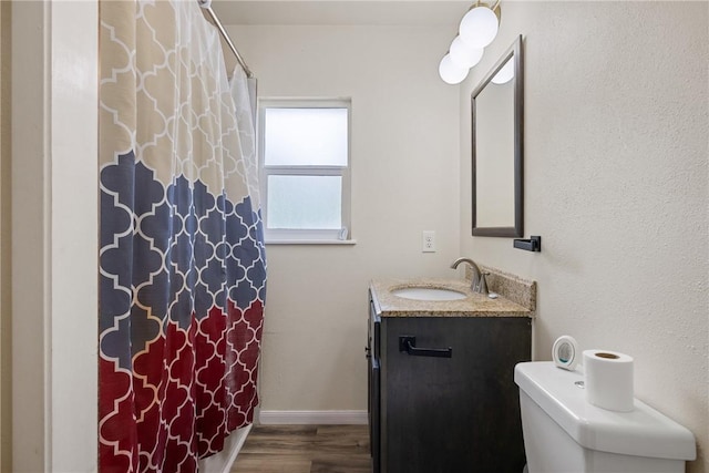 104 N Randolph Ave, Bryan, TX 77803 - full bathroom featuring wood finished floors, vanity, curtained shower, and toilet
