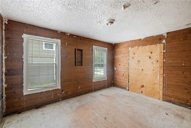 104 N Randolph Ave, Bryan, TX 77803 - empty room featuring wooden walls and a textured ceiling
