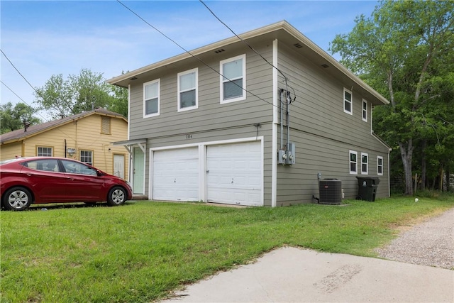 104 N Randolph Ave, Bryan, TX 77803 - view of home's exterior featuring cooling unit, a garage, and a lawn