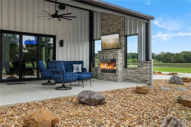 1923 County Road 202, Caldwell, TX 77836 - view of patio / terrace with an outdoor stone fireplace, ceiling fan, fence, and french doors