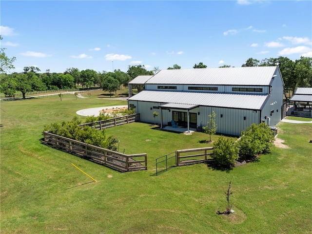 1923 County Road 202, Caldwell, TX 77836 - rear view of property featuring a pole building, metal roof, an outdoor structure, and view of scattered trees