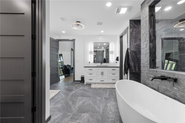 1923 County Road 202, Caldwell, TX 77836 - bathroom with marble tiled floors, a soaking tub, vanity, recessed lighting, and a walk in shower