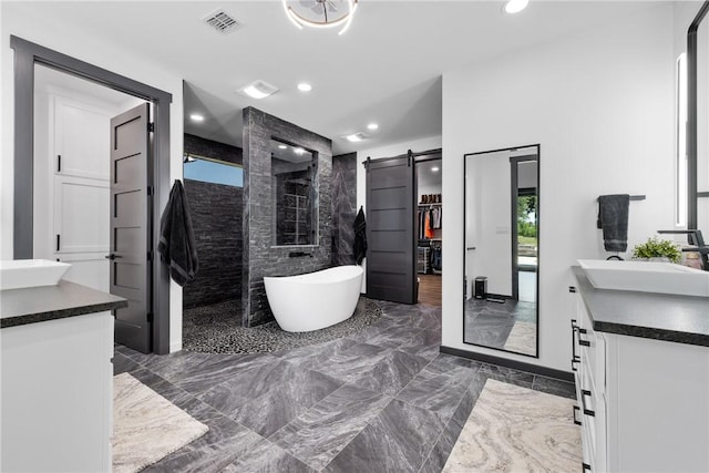 1923 County Road 202, Caldwell, TX 77836 - full bath featuring vanity, a walk in shower, a soaking tub, marble tiled flooring, and recessed lighting