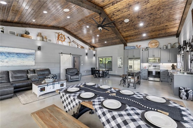 1923 County Road 202, Caldwell, TX 77836 - living area featuring a barn door, wooden ceiling, finished concrete flooring, high vaulted ceiling, and a ceiling fan