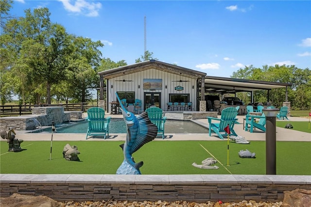 1923 County Road 202, Caldwell, TX 77836 - view of home's community featuring an area to practice putting, a patio area, fence, and an outdoor structure