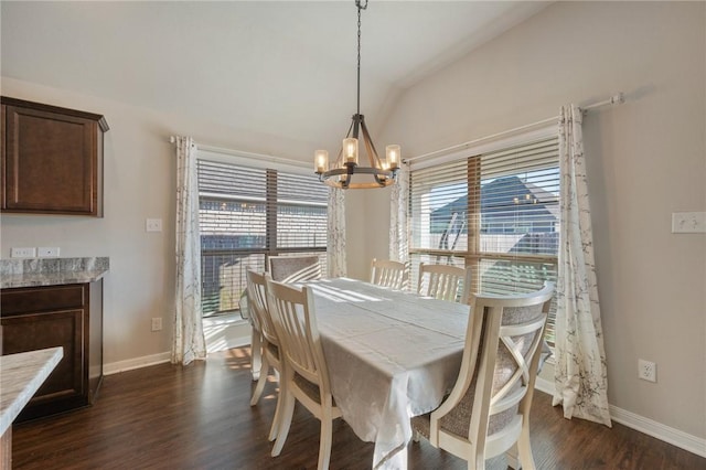 dining space featuring a chandelier, dark wood-type flooring, a healthy amount of sunlight, and vaulted ceiling