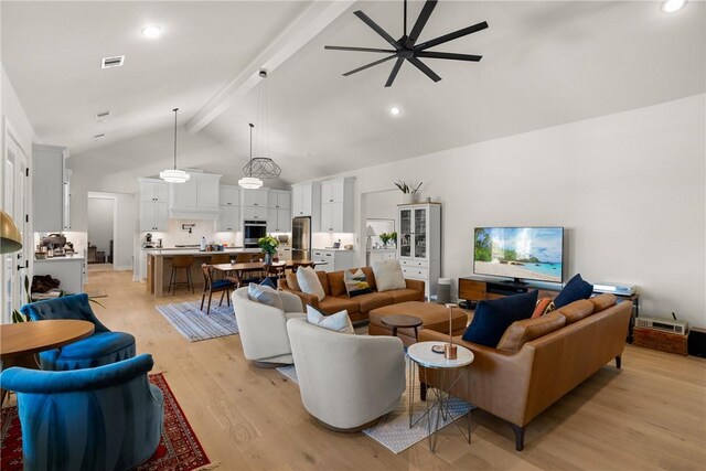 living room with visible vents, beamed ceiling, ceiling fan, high vaulted ceiling, and light wood finished floors