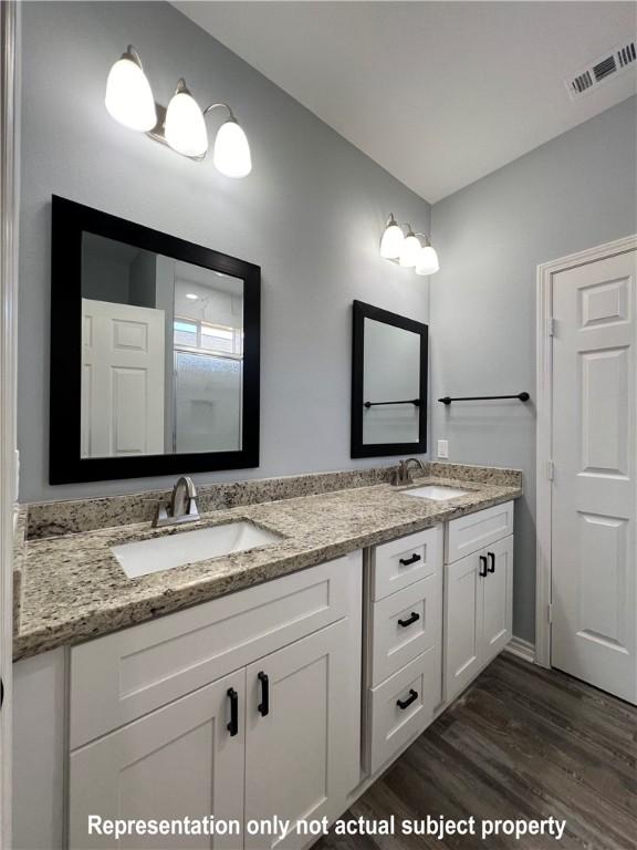 bathroom featuring vanity and hardwood / wood-style flooring