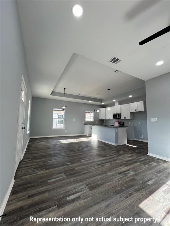 interior space featuring dark wood-type flooring and ceiling fan