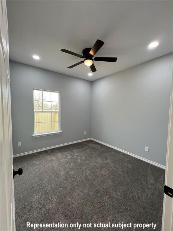 unfurnished room featuring dark colored carpet and ceiling fan