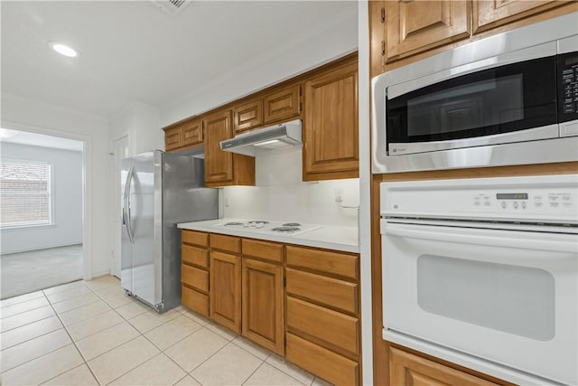 kitchen with light tile patterned flooring and appliances with stainless steel finishes