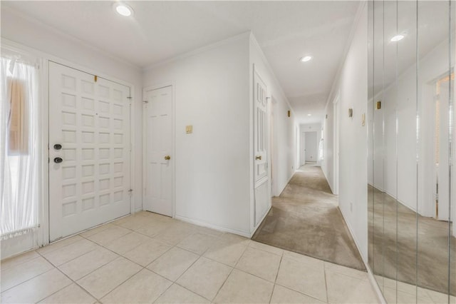 tiled foyer featuring crown molding