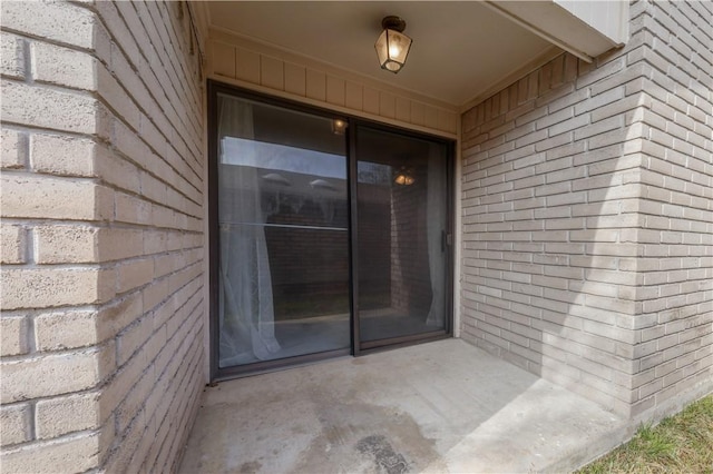 view of exterior entry featuring a patio