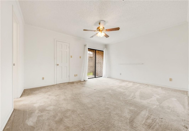 empty room with ceiling fan, a textured ceiling, and light colored carpet