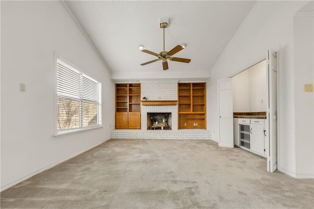 unfurnished living room featuring a fireplace, lofted ceiling, light colored carpet, and ceiling fan