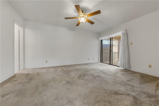 empty room with crown molding, a textured ceiling, and light colored carpet