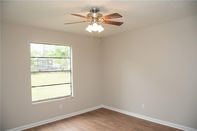 3023 Kim St, Bryan, TX 77803 - empty room featuring wood finished floors, baseboards, and a ceiling fan