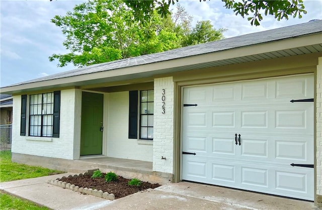 3023 Kim St, Bryan, TX 77803 - entrance to property featuring driveway, a garage, and brick siding