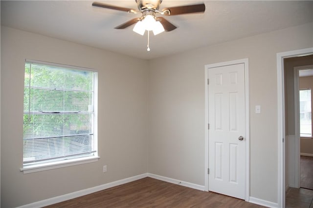 3023 Kim St, Bryan, TX 77803 - unfurnished bedroom featuring multiple windows, wood finished floors, and baseboards