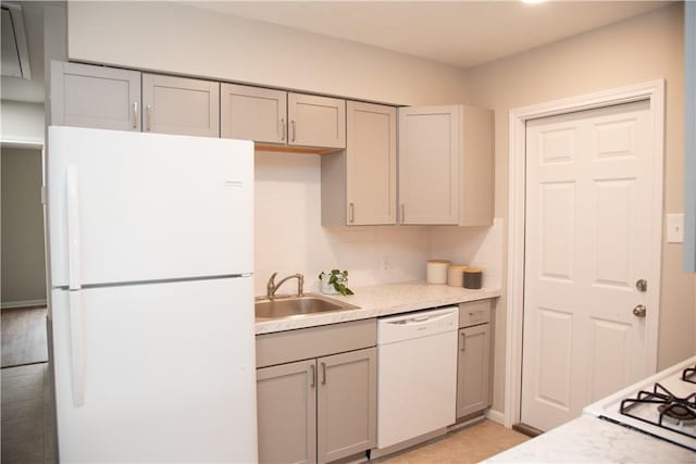 3023 Kim St, Bryan, TX 77803 - kitchen with white appliances, a sink, gray cabinets, and light countertops