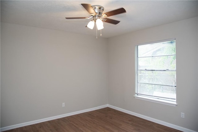 3023 Kim St, Bryan, TX 77803 - unfurnished room with plenty of natural light, dark wood finished floors, baseboards, and a ceiling fan