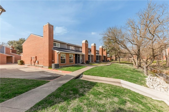 view of property's community with a lawn