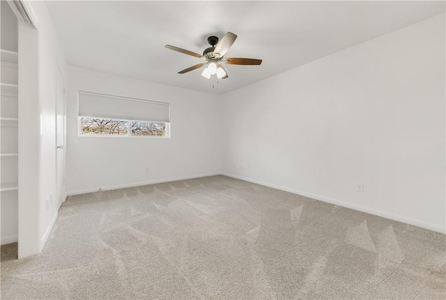 unfurnished room featuring ceiling fan and carpet