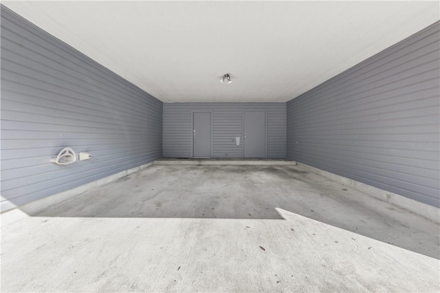 unfurnished room featuring concrete flooring