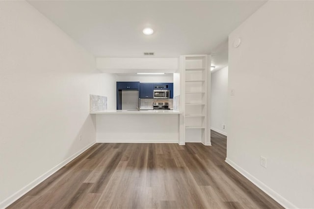 unfurnished living room featuring dark hardwood / wood-style floors