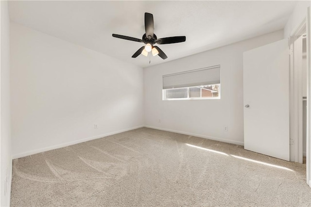 unfurnished room featuring ceiling fan and carpet flooring