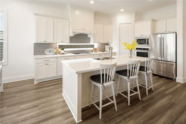 1932 Sherrill Ct, College Station, TX 77845 - kitchen with appliances with stainless steel finishes, a sink, wood finished floors, light countertops, and recessed lighting
