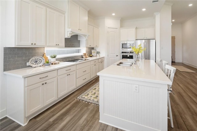 1932 Sherrill Ct, College Station, TX 77845 - kitchen featuring a sink, appliances with stainless steel finishes, tasteful backsplash, wood finished floors, and recessed lighting
