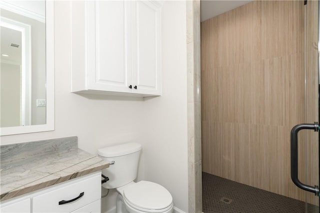 bathroom featuring vanity, toilet, and an enclosed shower