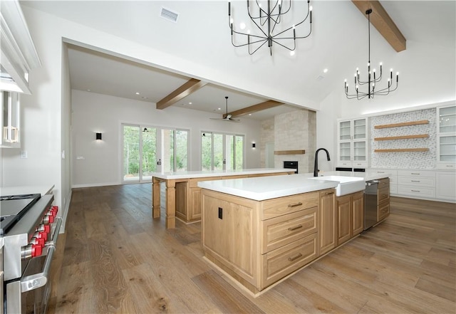 kitchen featuring sink, a center island with sink, ceiling fan, and appliances with stainless steel finishes