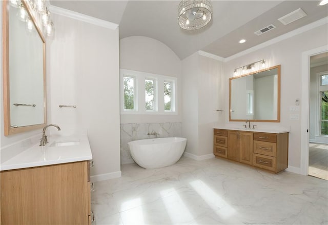 bathroom featuring a washtub, vanity, and ornamental molding