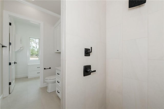 bathroom featuring tile patterned floors, vanity, toilet, and crown molding