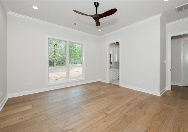 empty room featuring light hardwood / wood-style flooring, ceiling fan, and crown molding