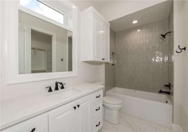 full bathroom featuring vanity, toilet, and tiled shower / bath