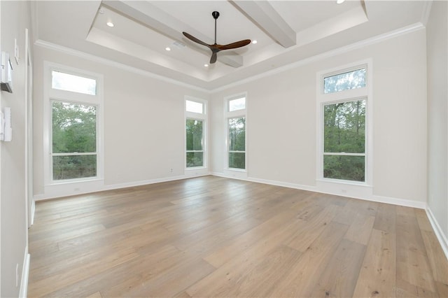 empty room with a wealth of natural light and light hardwood / wood-style flooring