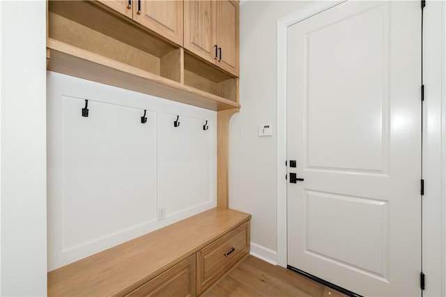 mudroom with light hardwood / wood-style flooring