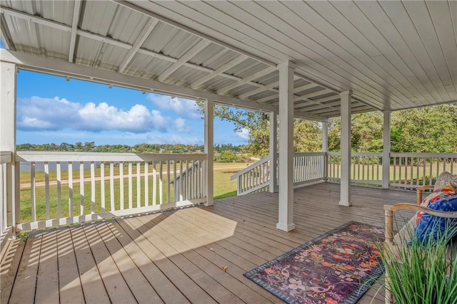 wooden deck with a lawn