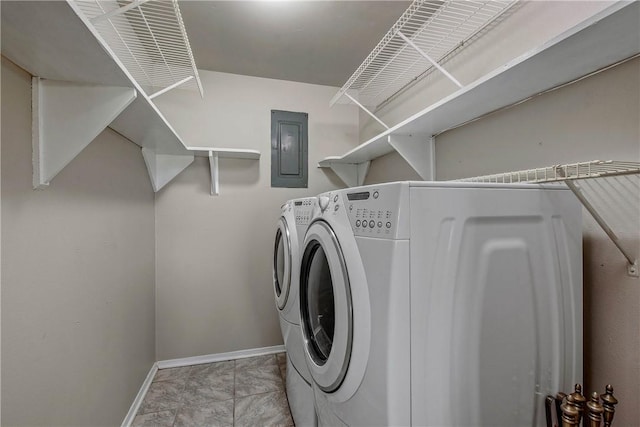 clothes washing area featuring electric panel and washer and clothes dryer