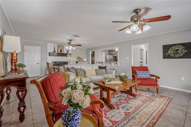 tiled living room with ceiling fan