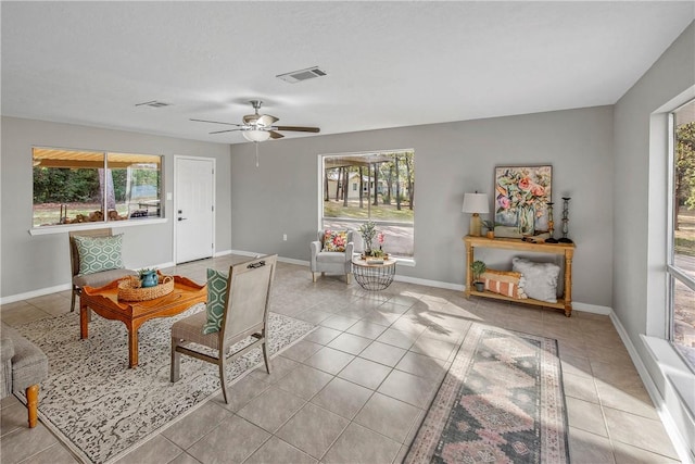 living room with light tile patterned floors and ceiling fan